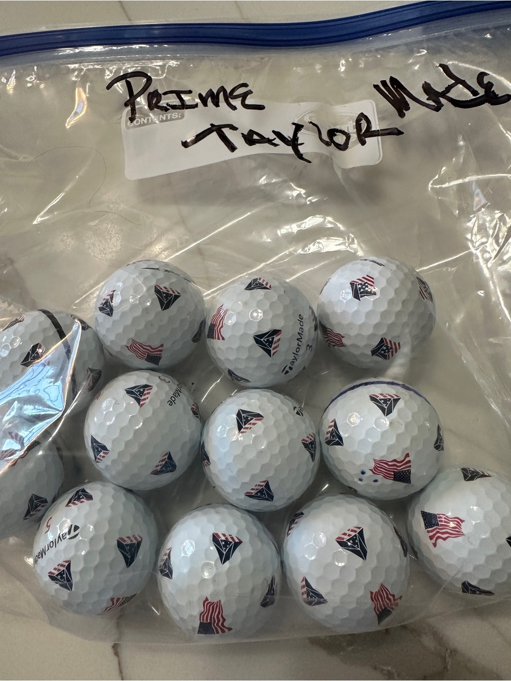 TaylorMade White Golf Balls with Red & Blue Flag Accents - 12 per Pack
